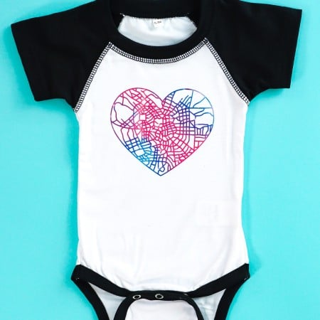 Cricut Infusible Ink bodysuit on teal background