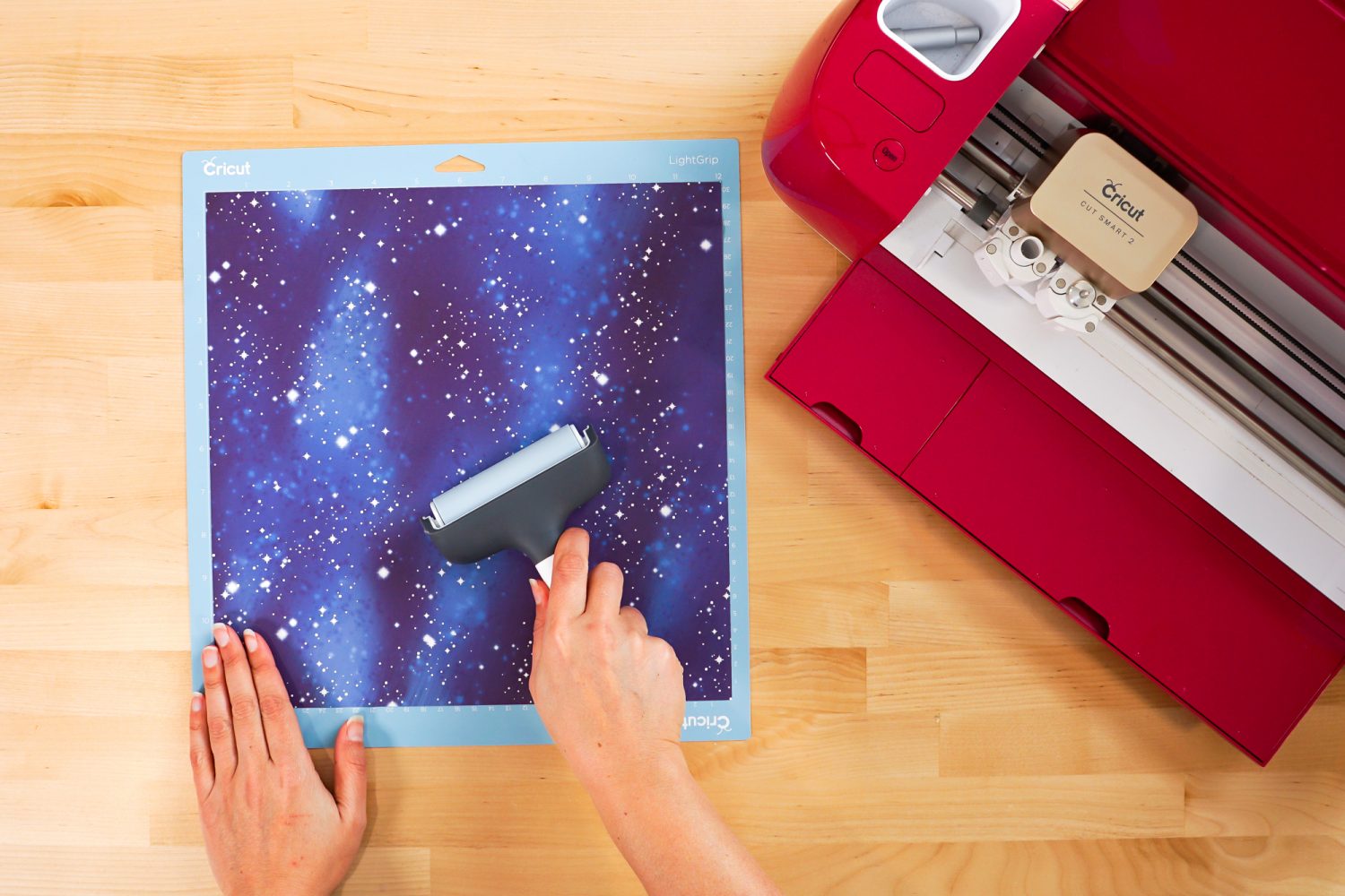 Use a brayer to press down the transfer sheet on the mat