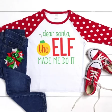 White t-shirt with red and white polka dot sleeves with the saying Dear Santa, The Elf Made Me Do It