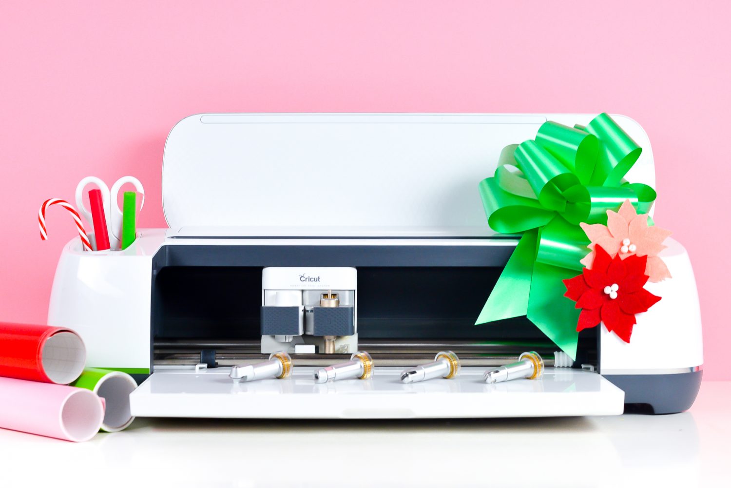 Cricut Maker "decorated" for Christmas with candy cane and bow plus matching materials