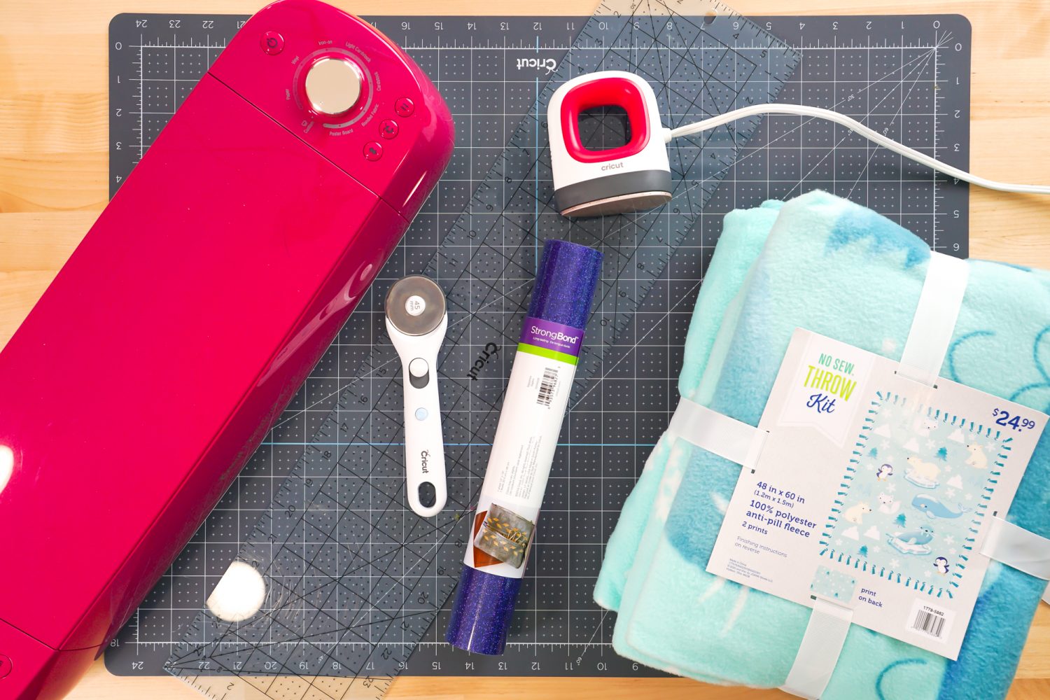 Supplies needed for this project: Cricut Explore, fleece blanket kit, rotary cutter, ruler, cutting mat, EasyPress Mini