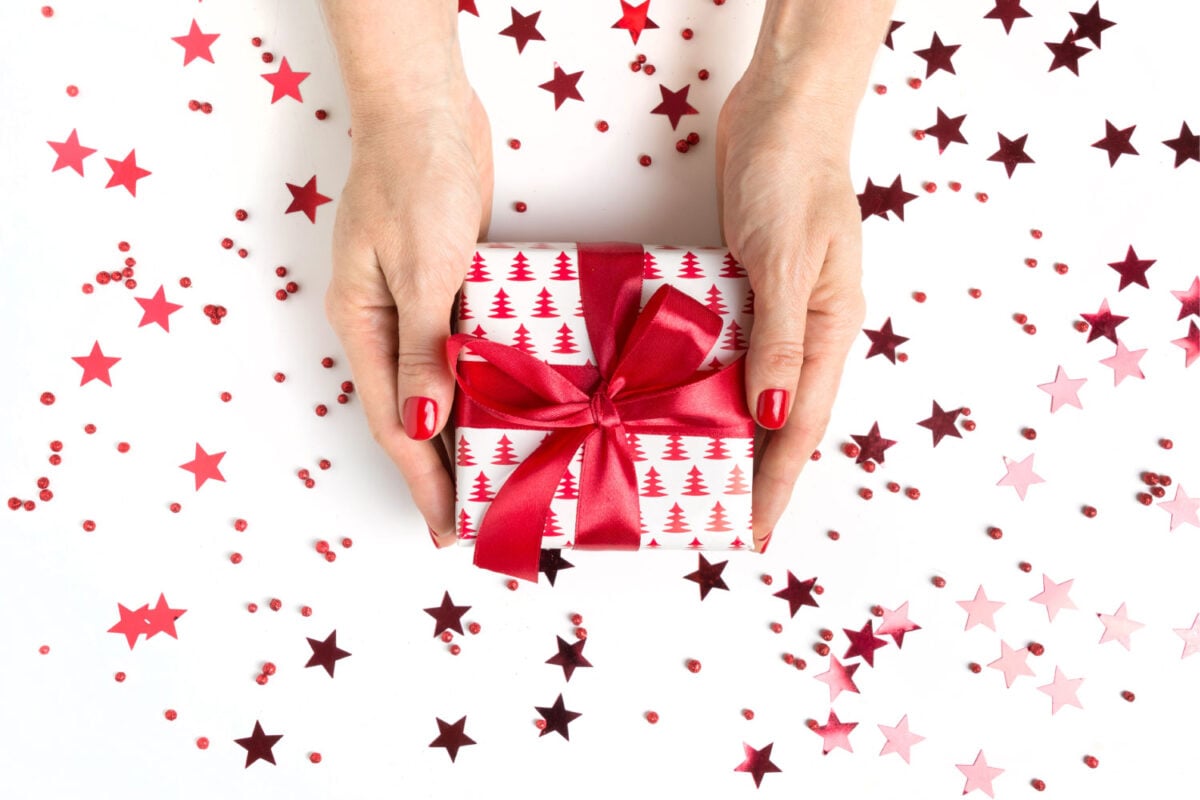 Hands holding present wrapped for Christmas