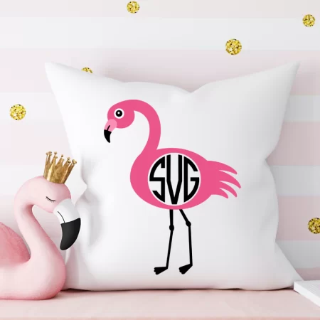 White pillow with a monogrammed flamingo on it