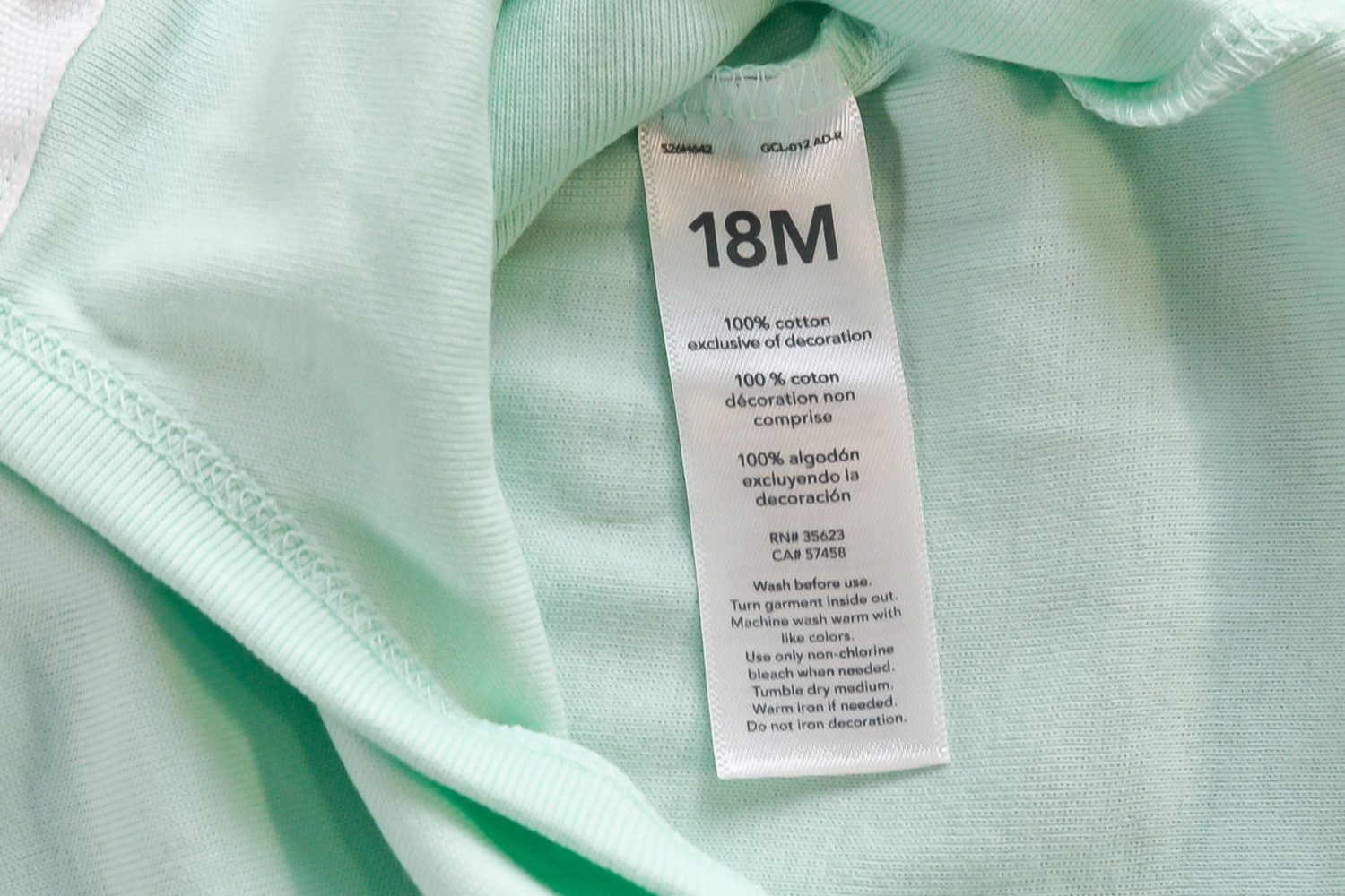 Closeup of 18M cotton onesie tag