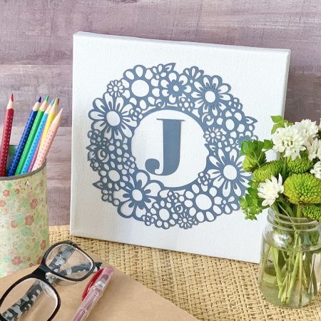 White canvas with a floral monogram on it