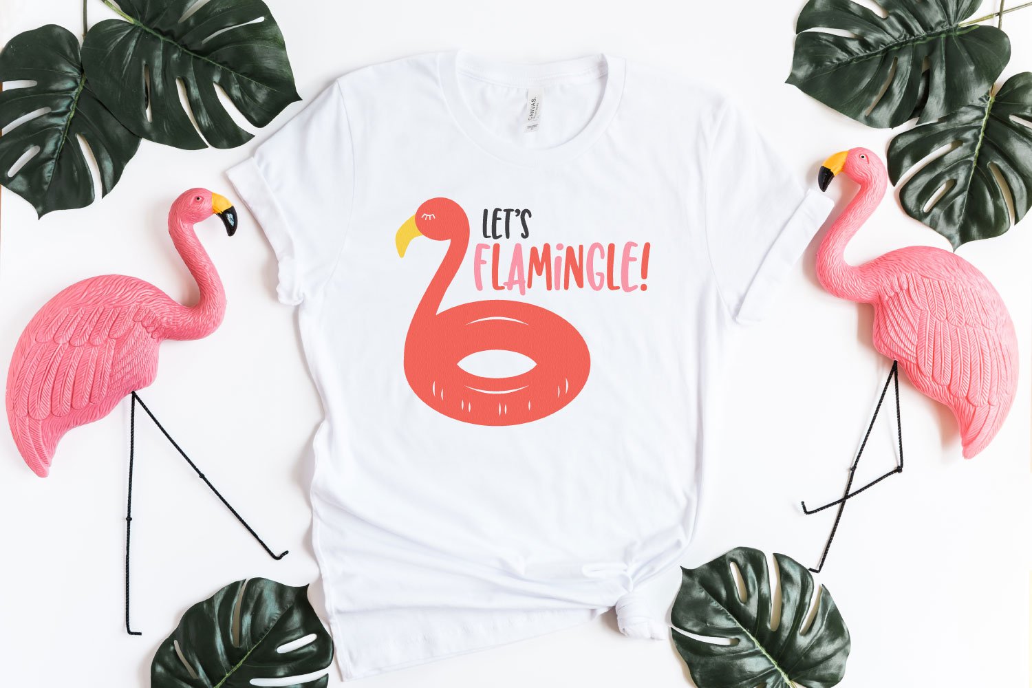 Let's Flamingle SVG on white shirt with plastic flamingoes