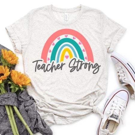 T-shirt with and image of a rainbow and the words Teacher Strong