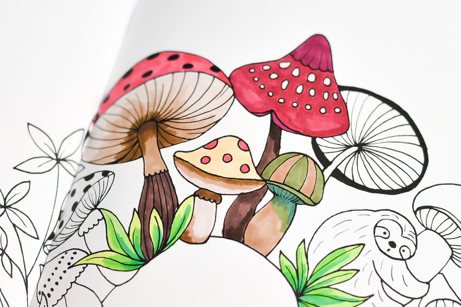 Close up of coloring book with blended colored mushrooms