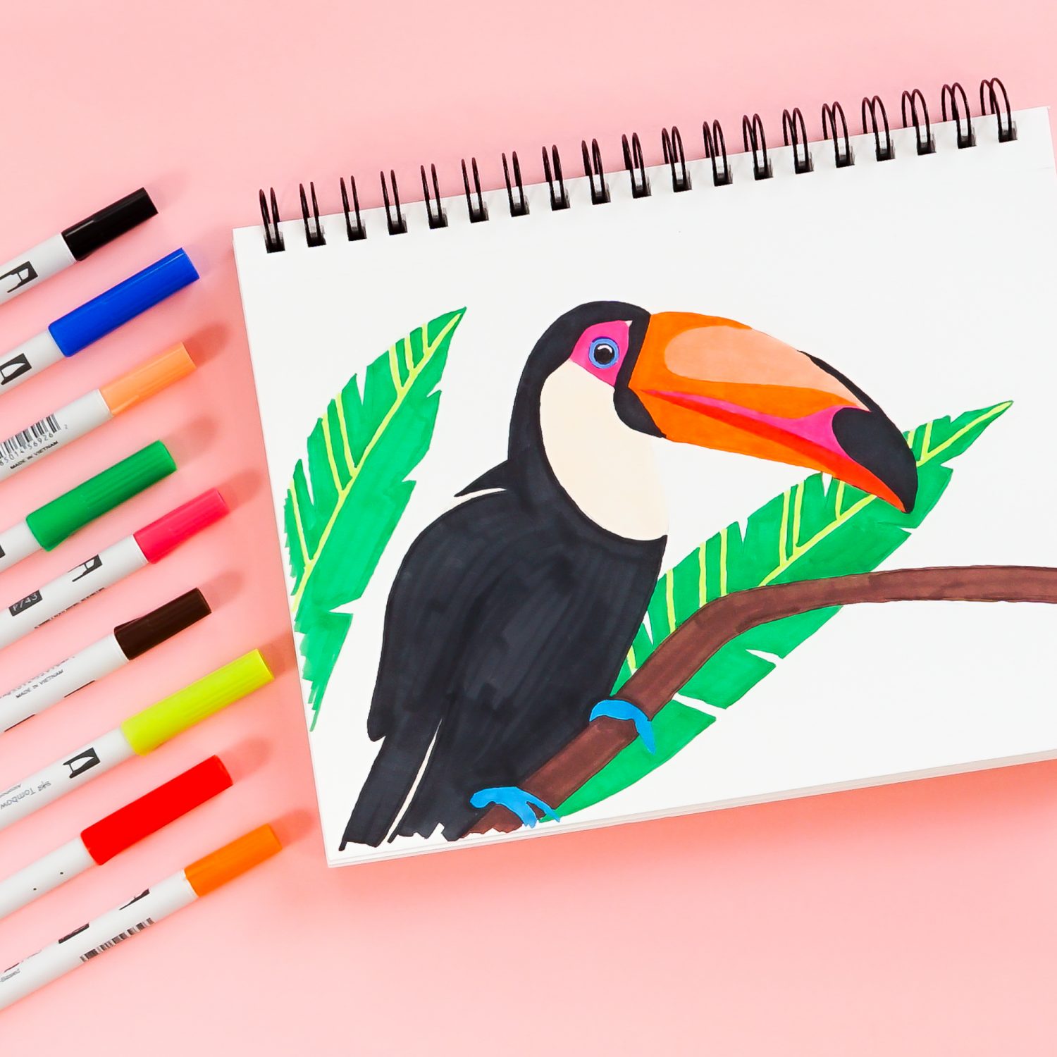 Toucan illustration with Tombow ABT PRO Markers surrounding the drawing