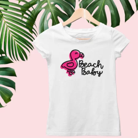A white toddler t-shirt with an image of a baby flamingo on it and the saying Beach Baby