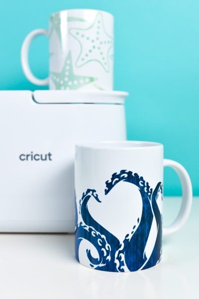 Cricut Mug Press with two sea-themed mugs