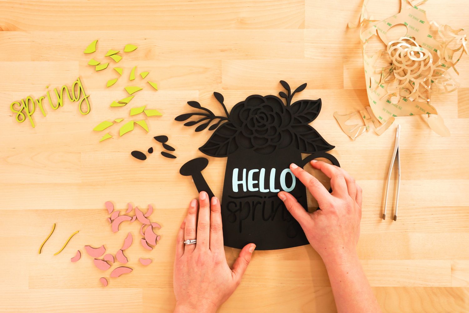 Hands placing the letters in the sign.