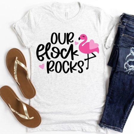 A pink flamingo on a white t-shirt with the saying Our Flock Rocks