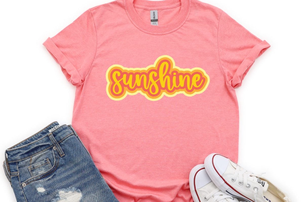 Sunshine image on pink shirtAfter many years of asking, Cricut users can now offset their designs in Cricut Design Space! An offset is basically a solid outline/shadow around text or images. The new Cricut offset tool makes it easy!