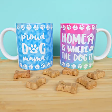 Two mugs, one with saying Home is where the dog is and the other with Dog Mama