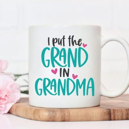 A white coffee cup that says I put the Grand in Grandma