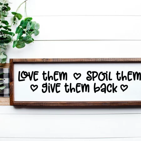 A wooden framed sign that says Love Them Spoil Them Give Them Back