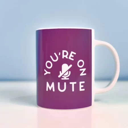 Coffee mug decorated with a purple background and the words You're On Mute