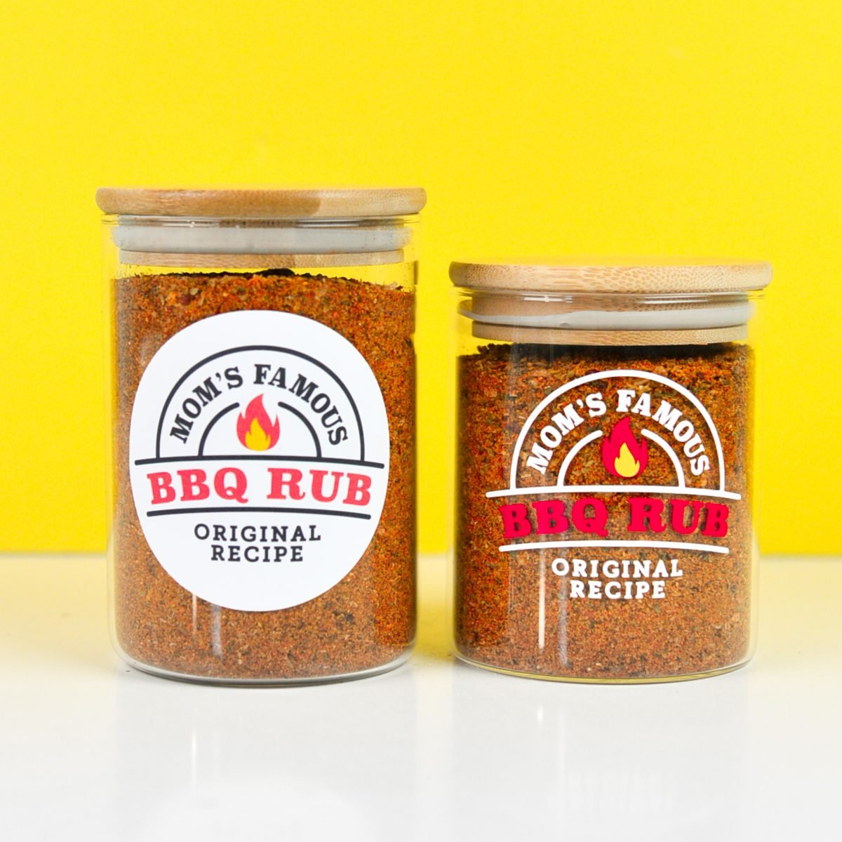 Two jars with two BBQ labels in front of a yellow background