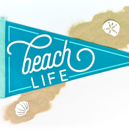 Beach Life Pennant on white background with sand