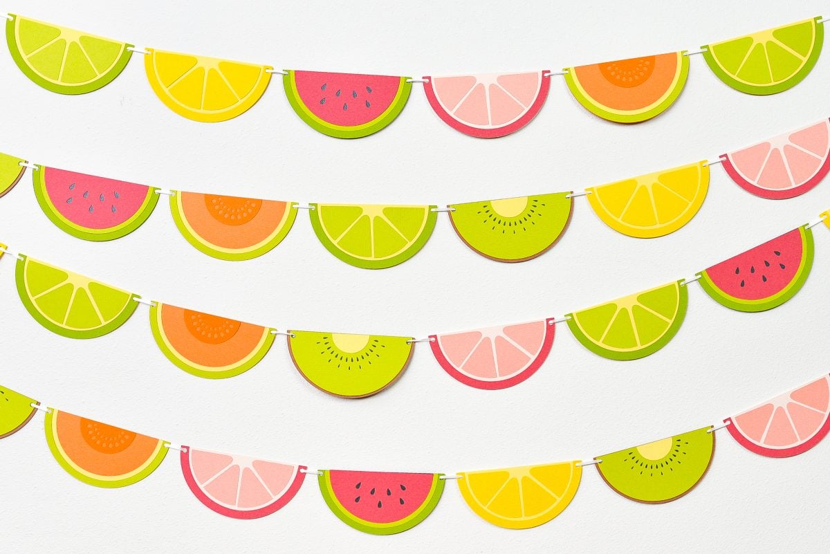 Finished fruit slice banner hanging on a white wall.