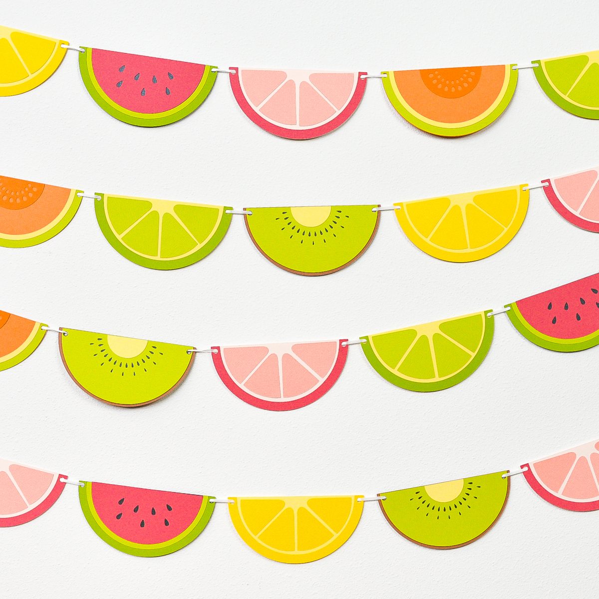 Finished fruit slice banner hanging on a white wall.