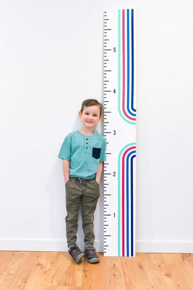 Boy standing with height ruler
