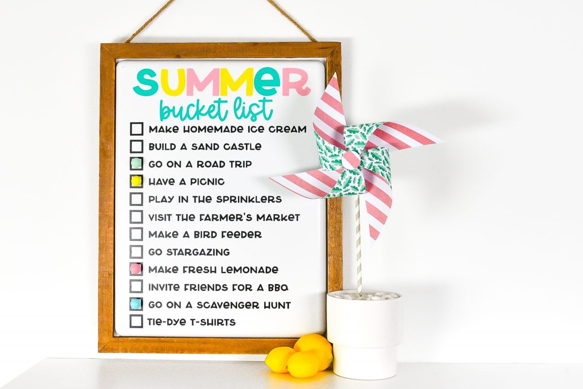 Finished summer bucket list board staged with lemons and a pinwheel.