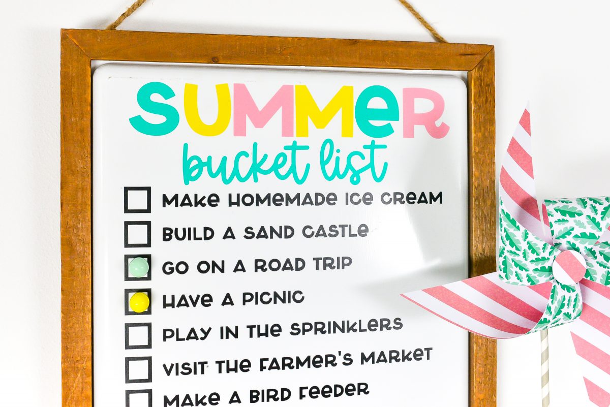 Finished summer bucket list board staged with lemons and a pinwheel.