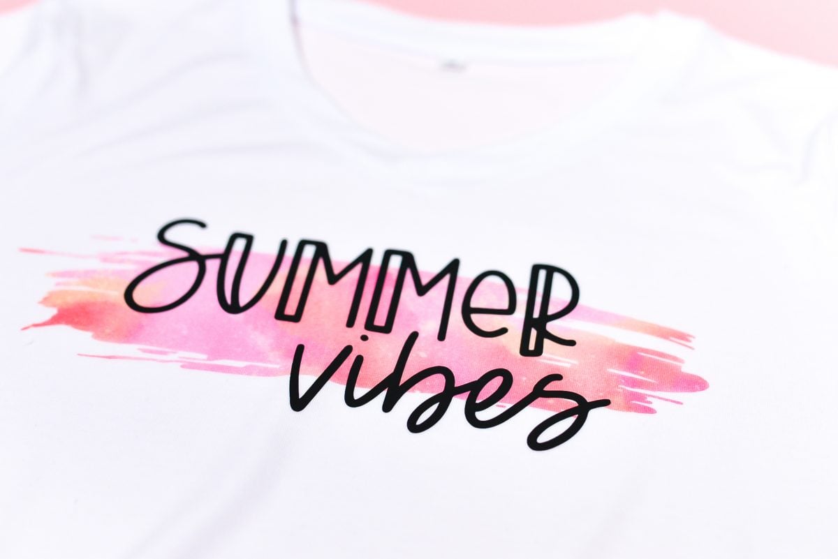 Final Summer Vibes shirt staged with flip flops, water bottle, and shorts on pink background
