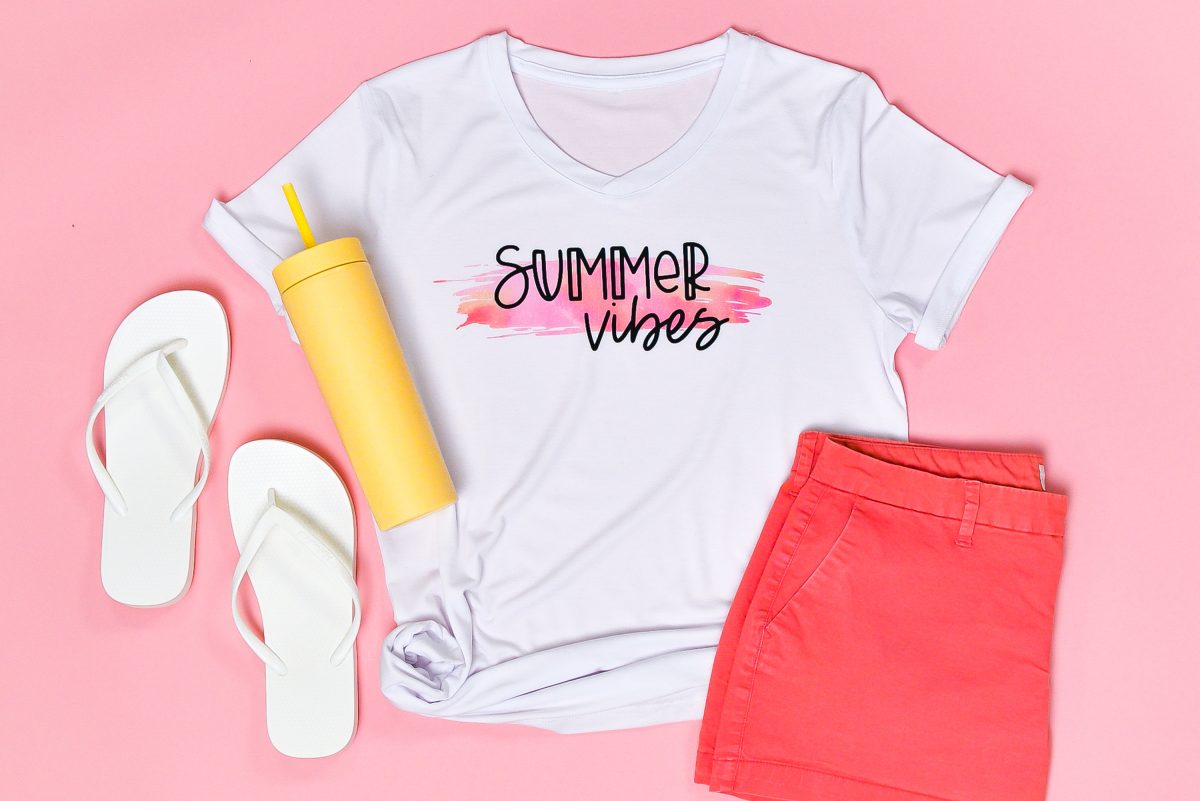 Final Summer Vibes shirt staged with flip flops, water bottle, and shorts on pink background