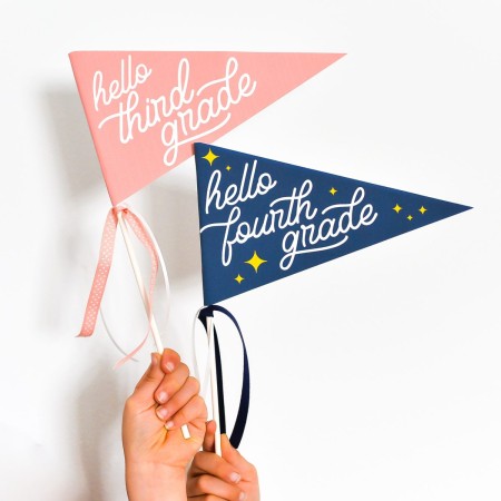 Kids hands holding back to school flags