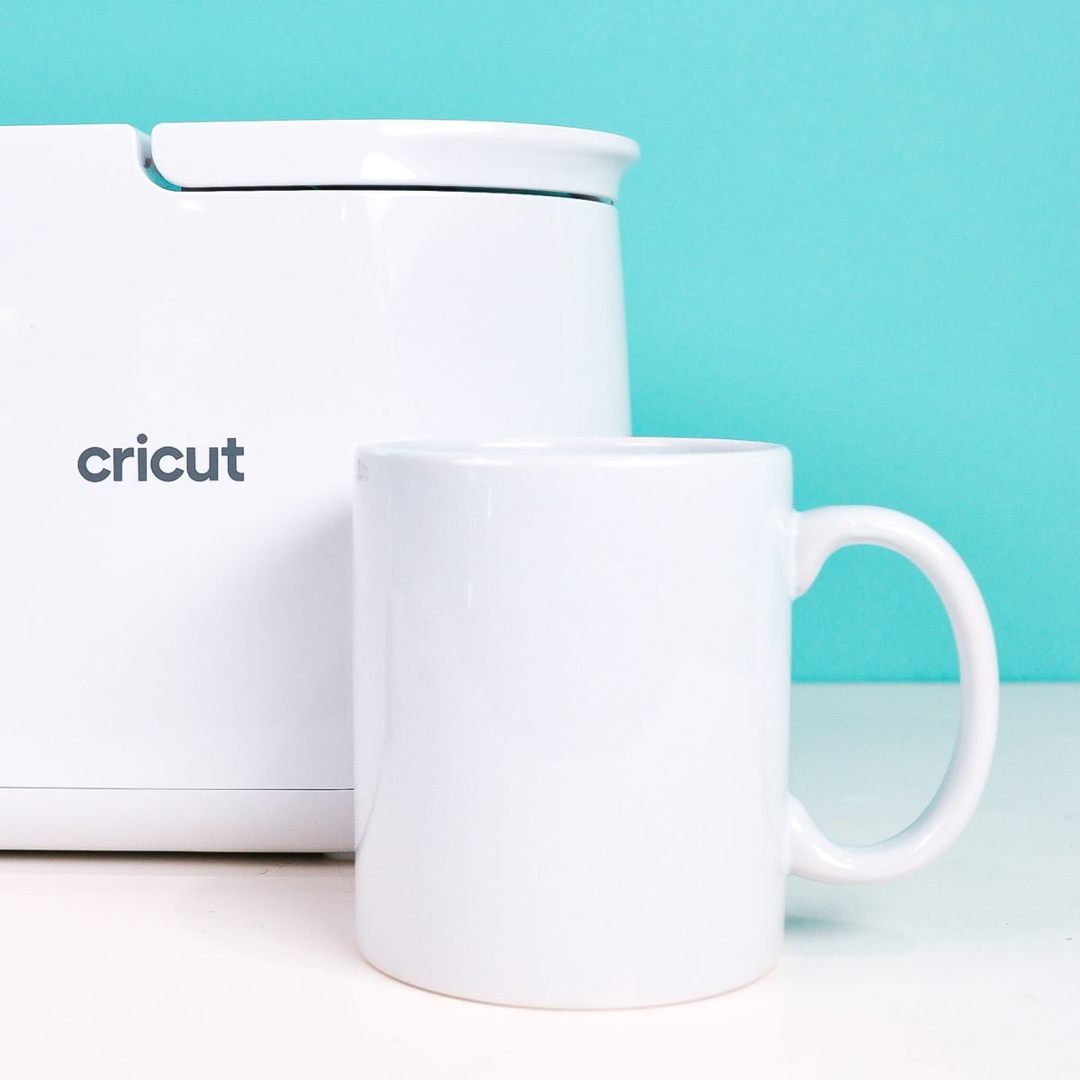 Blank Cricut mug in front of Cricut Mug Press