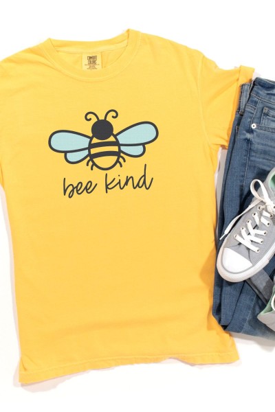 Blue jeans, gray tennis shoes and a bright yellow t-shirt with a bee on it and the saying bee kind