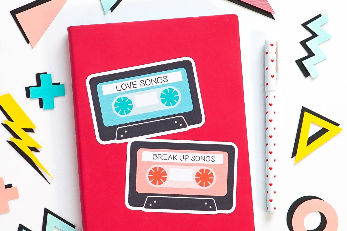 Pink notebook with big mix tape sticker, surrounded by 80's shapes