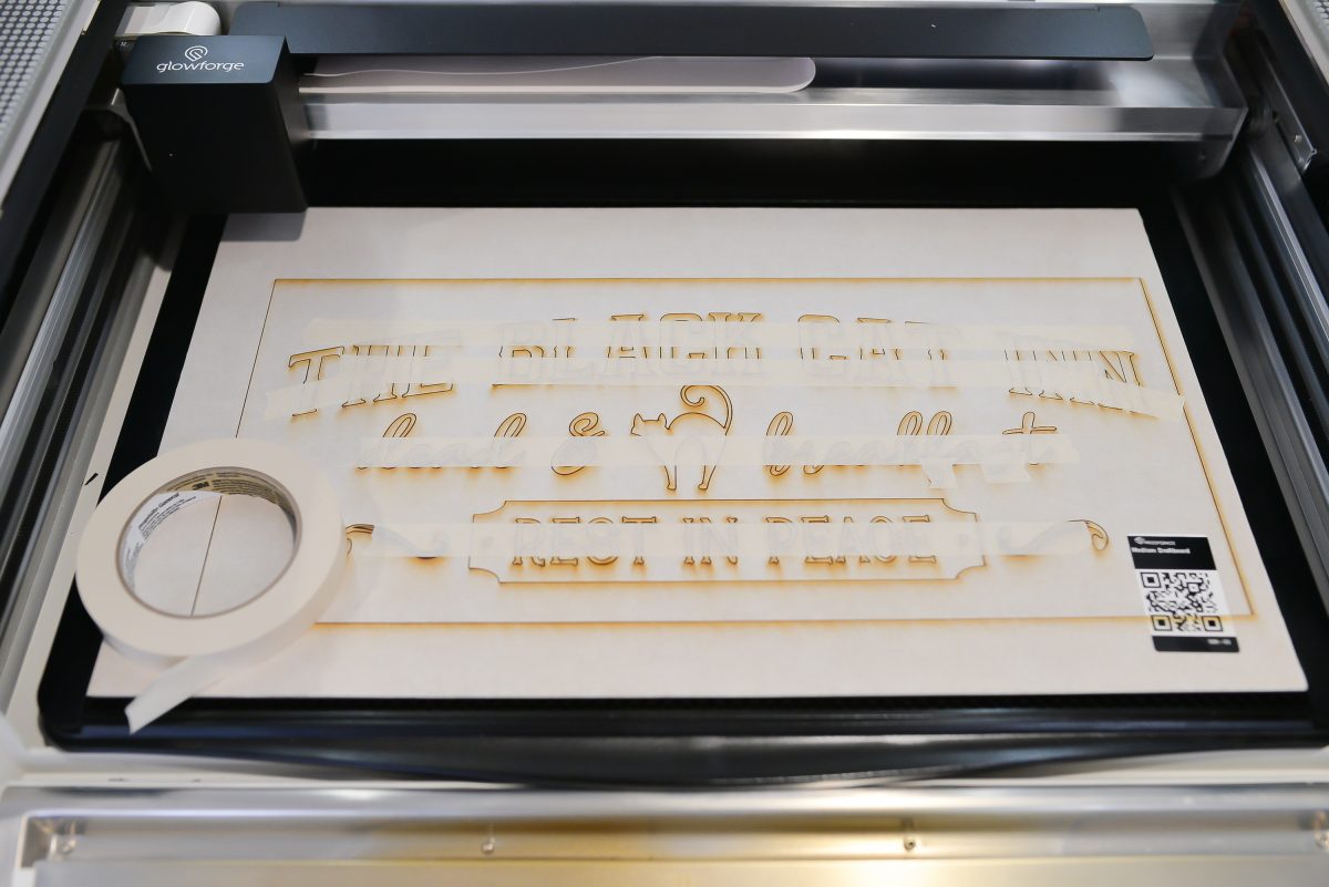 Masking tape over the letters on the sign to make it easier to remove from the Glowforge.