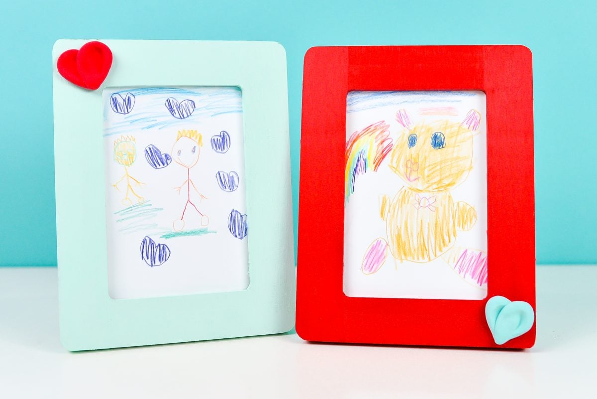 Framed children's artwork: a bear and a grandma and grandpa. Red and teal frames.