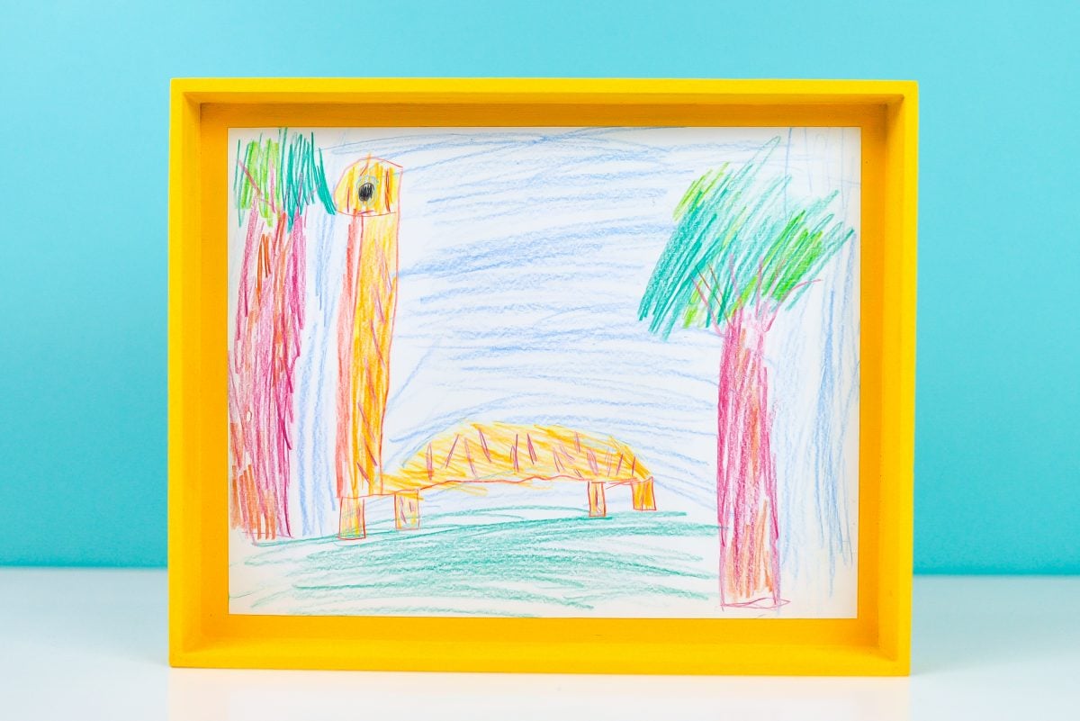 Yellow tray inset with child's drawing of a giraffe.