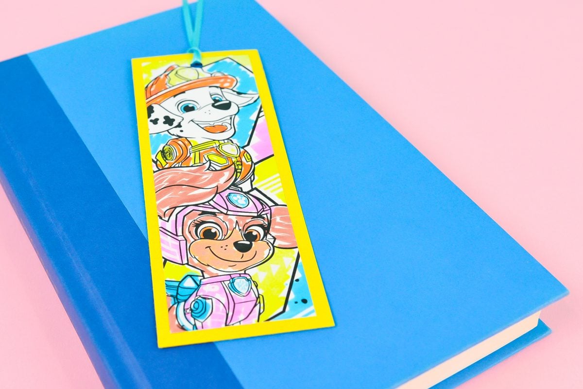 Bookmark made from Paw Patrol coloring pages and cardstock, on blue book.