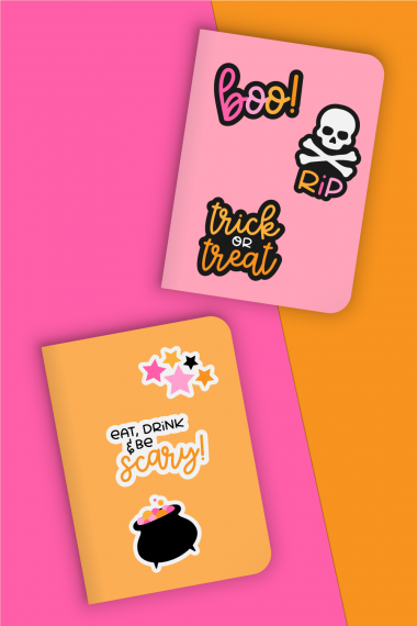 Halloween stickers on pink and orange notebooks.