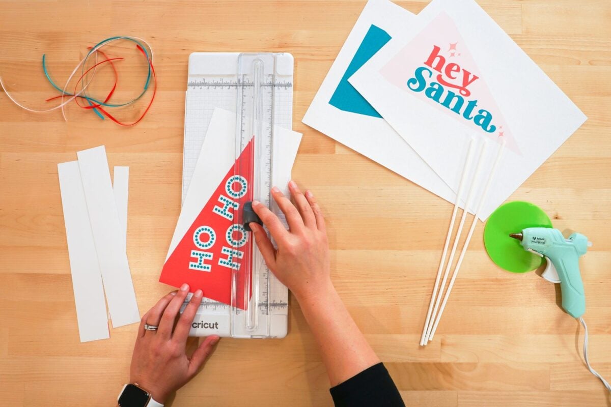 Hand cutting pennant flag in paper cutter