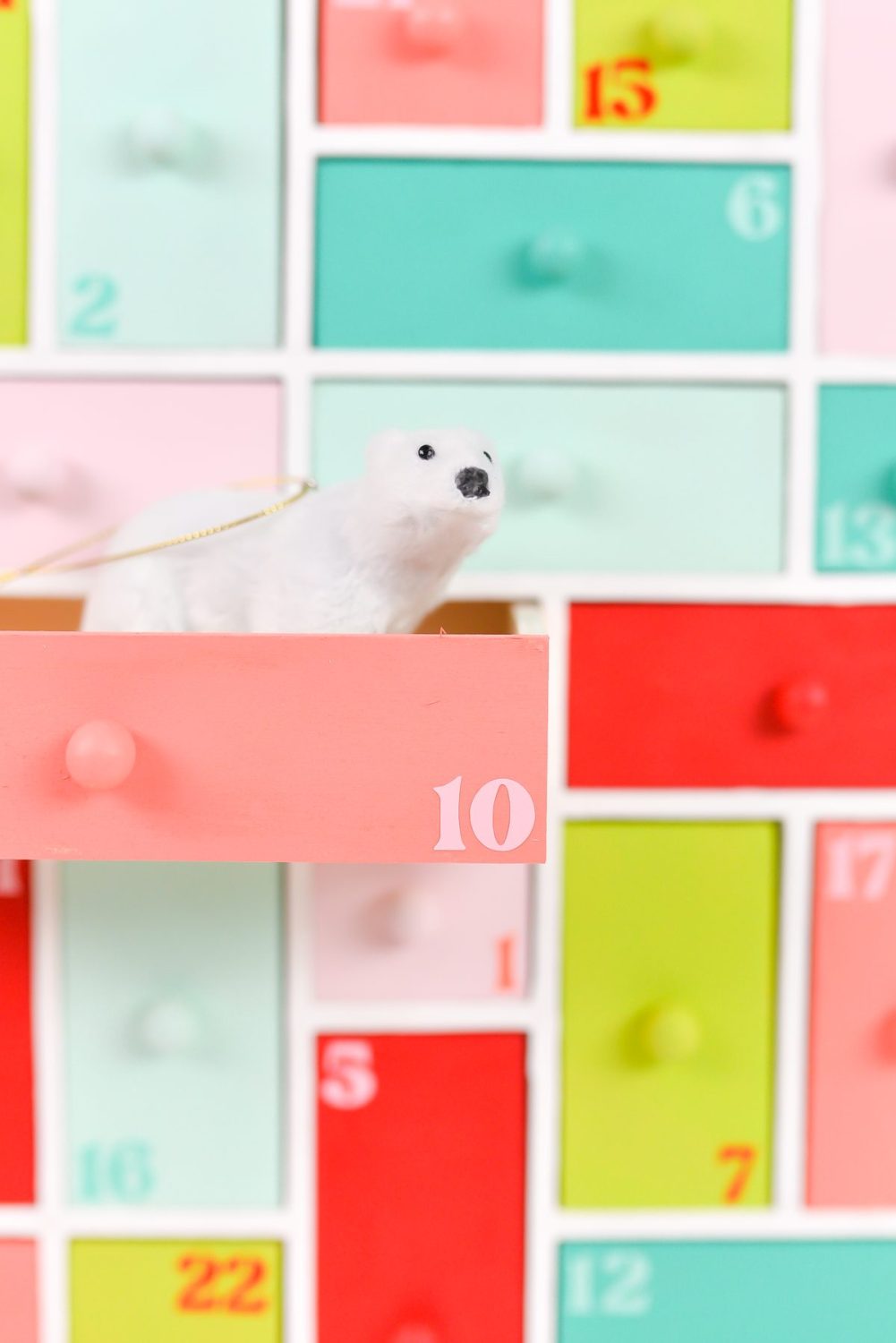 Closeup of painted wooden advent calendar with polar bear ornament