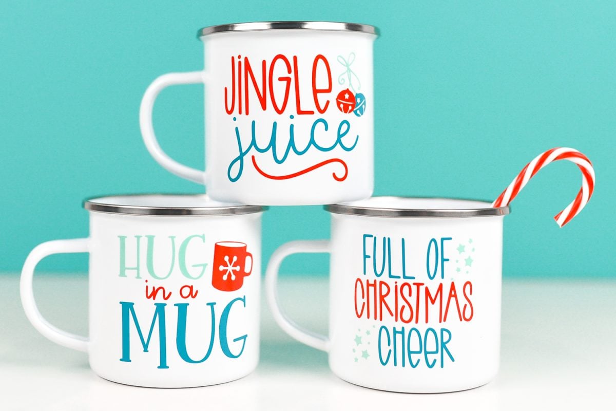 Final DIY Christmas mugs with blue background and candy cane.