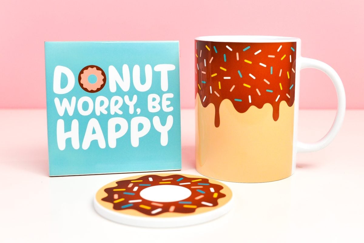 Sublimation on ceramic tile, mug, and coaster, all with a donut theme.