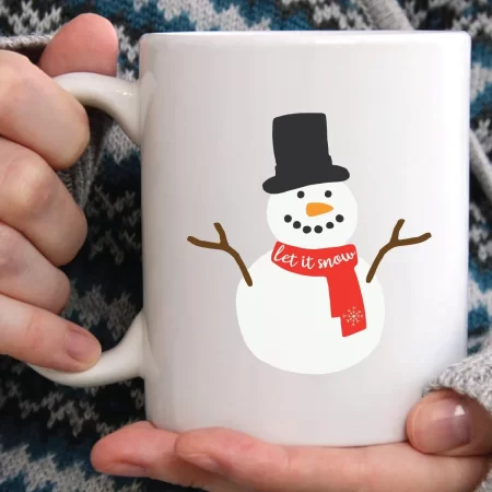 Woman holding a coffee mug with a snowman on it and the saying Let it Snow