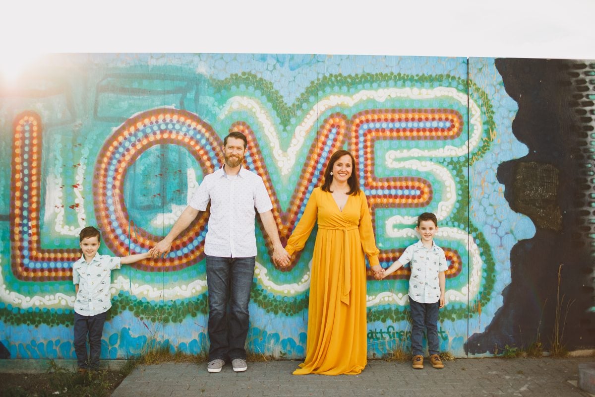 The George Family standing in front of a huge Love sign