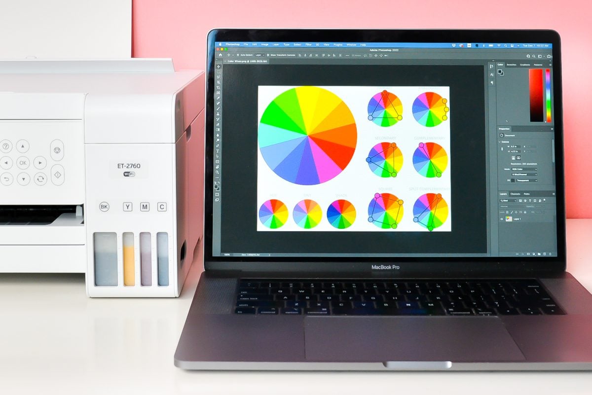 Laptop with color wheel image on screen and sublimation printer
