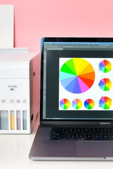 Laptop with color wheel image on screen and sublimation printer