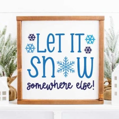 Framed sign that says Let it Snow Somewhere Else