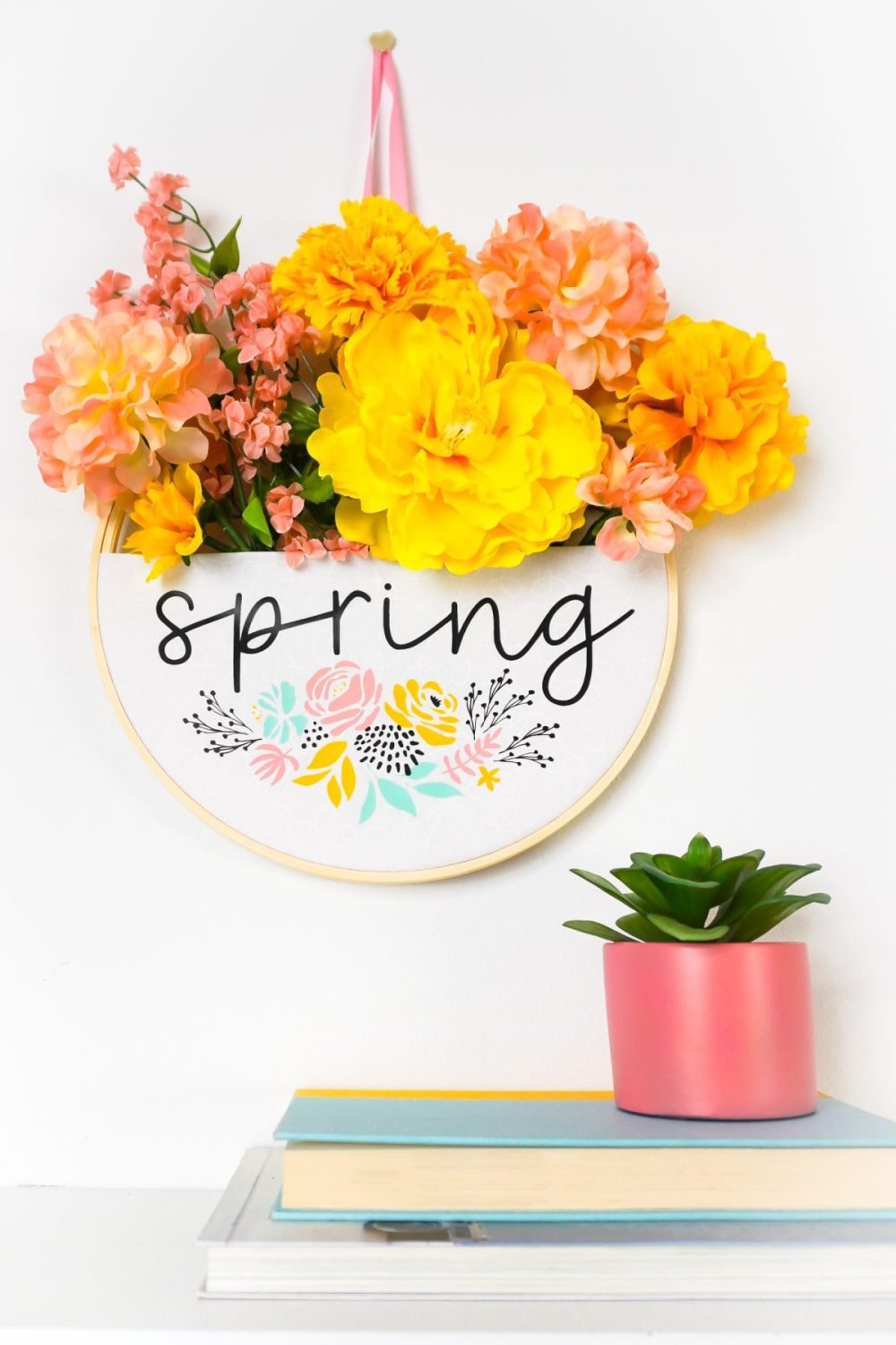 Spring embroidery hoop wreath hanging on a wall